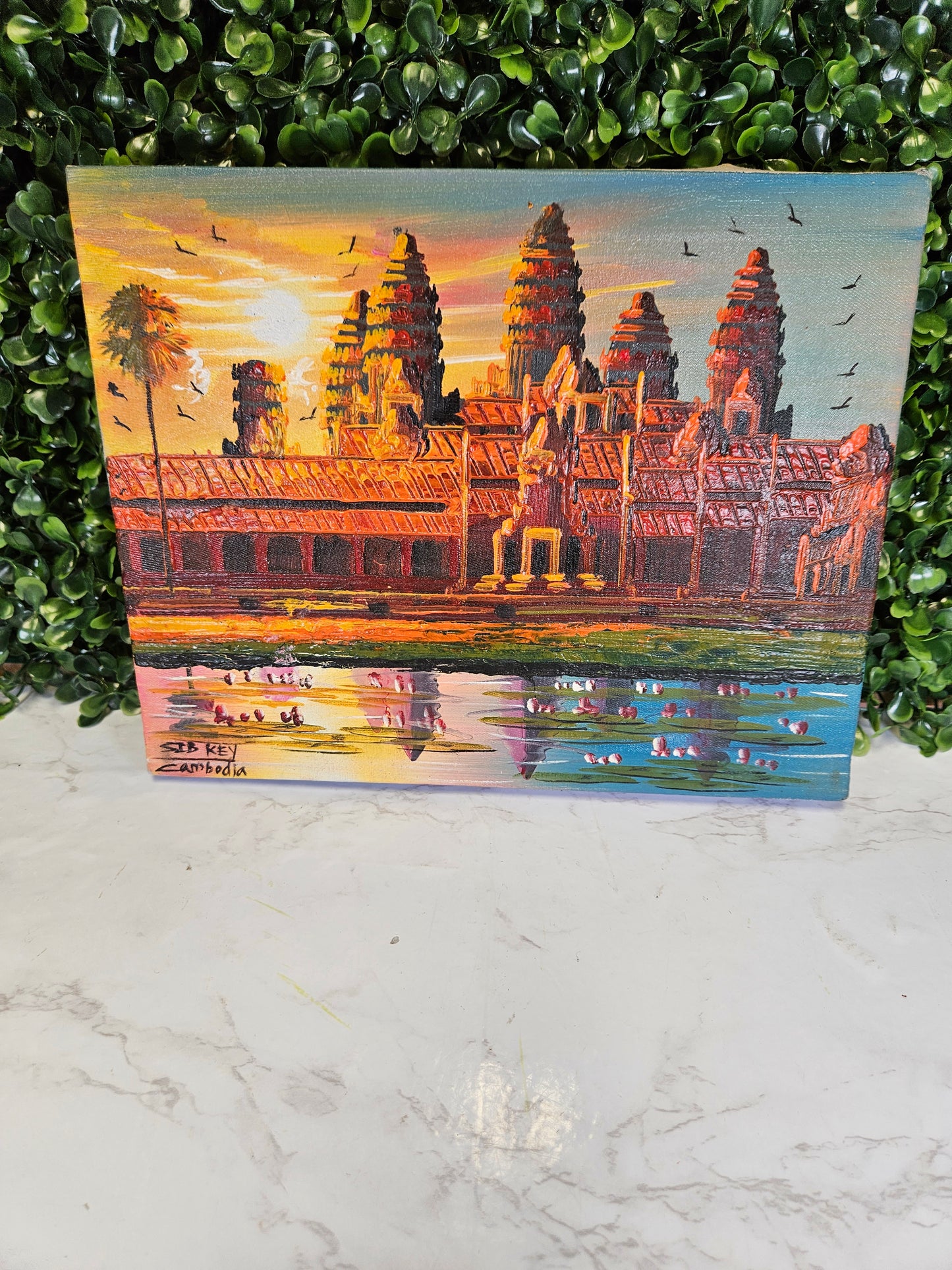 Vintage Cambodia painting on a purple fabric background