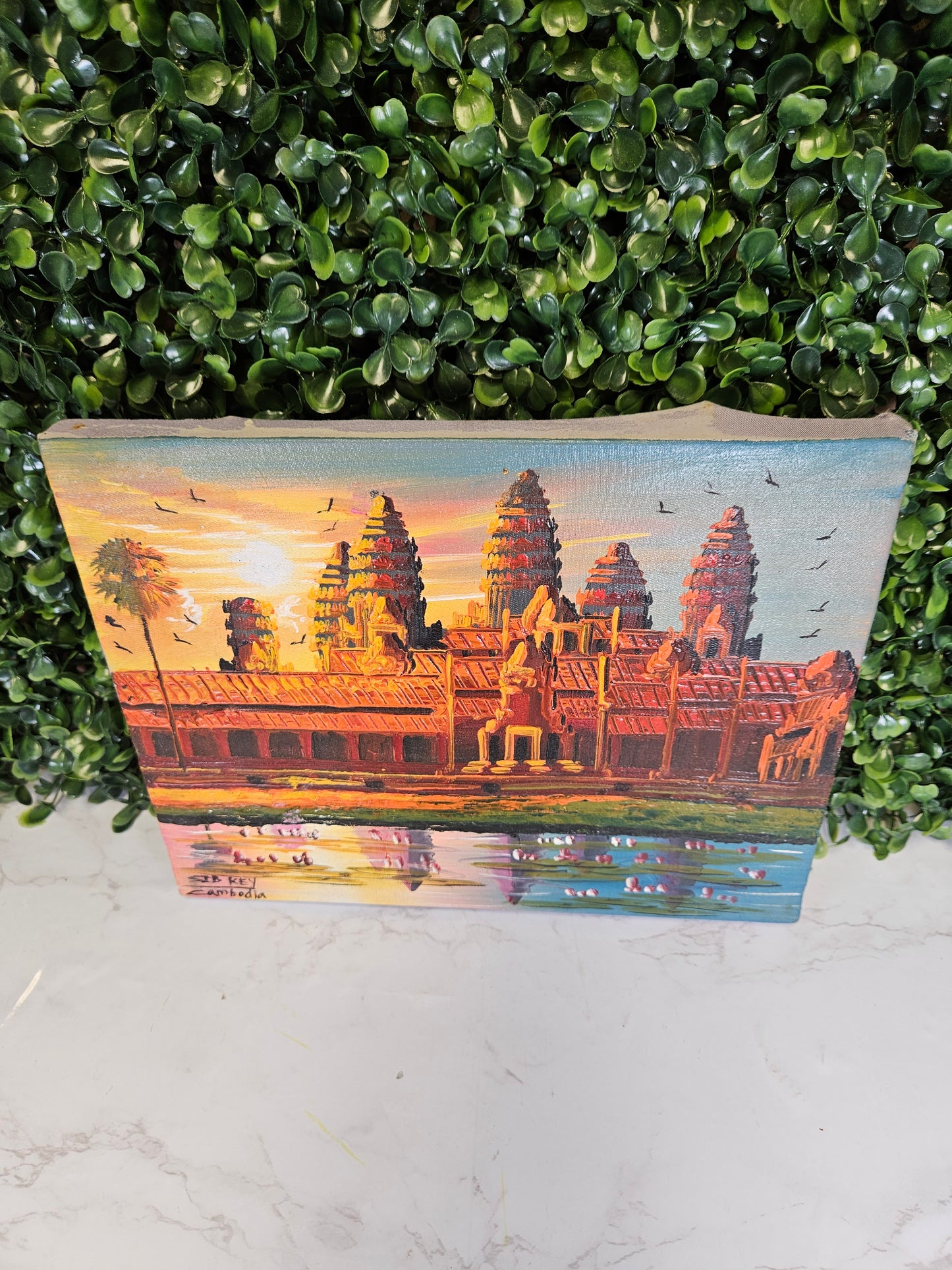 Vintage Cambodia painting on a purple fabric background